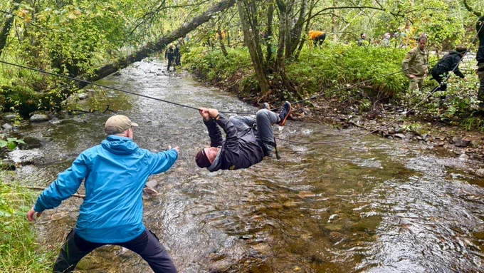 Employers crossing a river.
