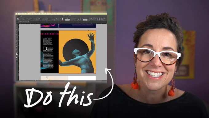 Khara Plicanic smiling at the camera in front of a computer screen with indesign on it