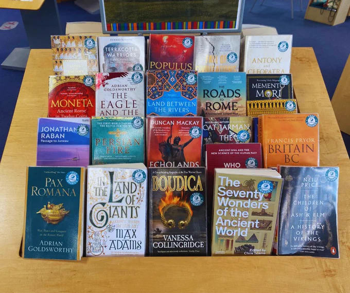 A photo of a non-fiction book display in Godalming Library showing rows of Ancient History books with turquoise stickers in the corner that say ‘TRUE.’ 
