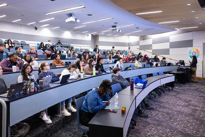 UB students participate in a class held in a lecture hall at UB's Pharmacy Building. 