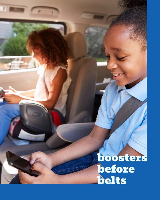 "Boosters before belts" image showing two older children smiling and sitting in backless booster seats in the car