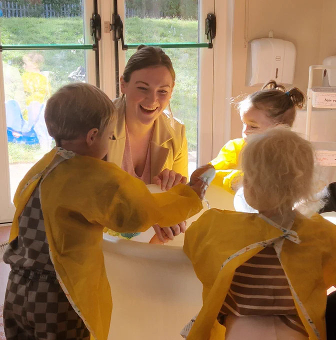 Natalie Don-Innes, Minister for Children, Young People and The Promise playing with children on a nursery visit.
