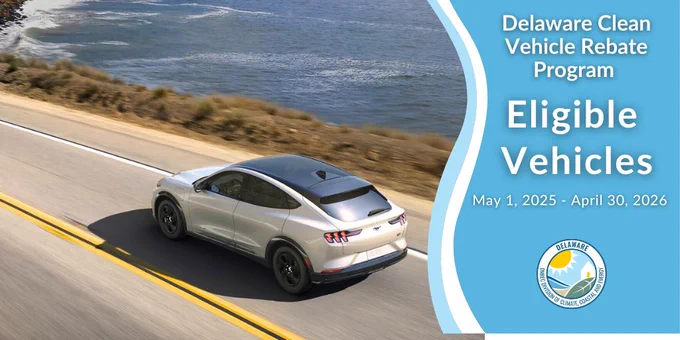An electric vehicle navigates a curve in the road.