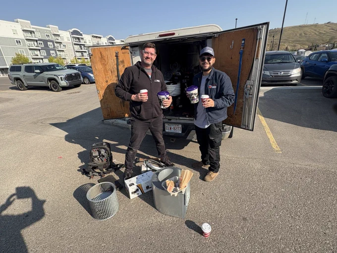 A group of Air West Mechanical technicians standing together in Calgary, ready to provide heating and cooling services, wearing uniforms with company logos, smiling and looking professional.