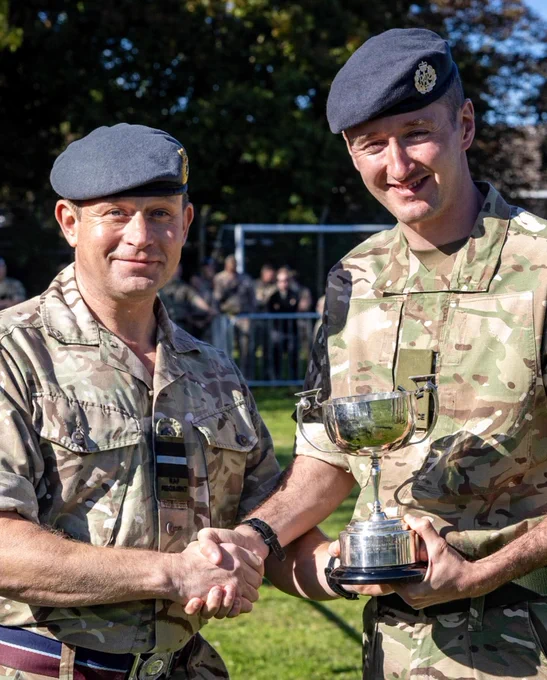 Air Cdr Hamilton presenting Cpl Sargeant and MWD Sepp with the second place trophy