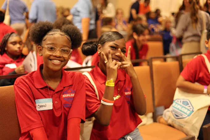 Two students smile for a photo. 