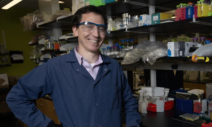 Mark Styczynski poses in his lab.