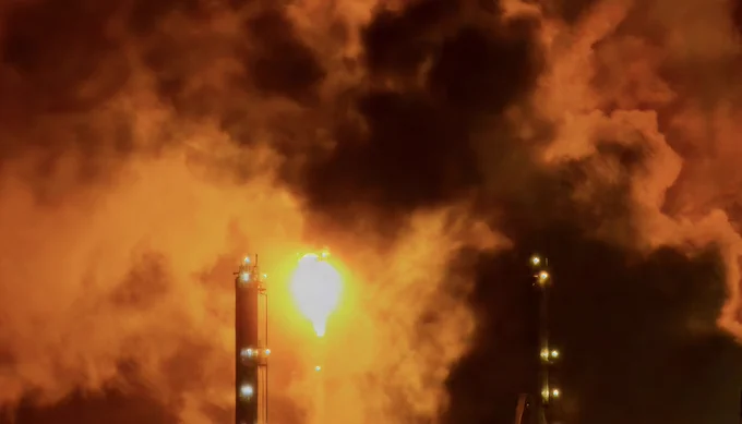 Image depicts a flare and smoke from a separate refinery incident, which occurred in 2024.