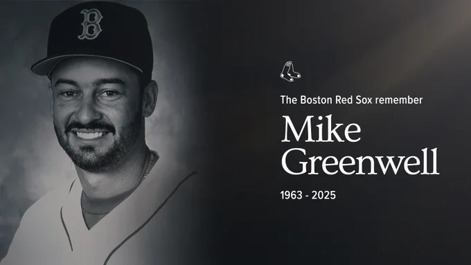 TEXT: "The Red Sox Remember Mike Greenwell- 1963-2025" 
IMAGE: Black and white photo shows Mike Greenwell smiling in Red Sox home white uniform as he poses for a portrait. 