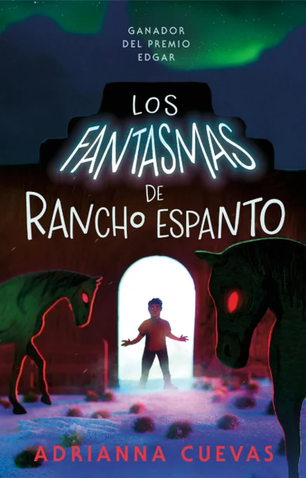 A book cover that reads "Los fantasmas ee Rancho Espanto" by Adrianna Cuevas. A boy stands with a white light coming from a doorway behind him. In front of him and on either side are two horses with red eyes. The artwork is in haunted hues of reds, blues, and greens.