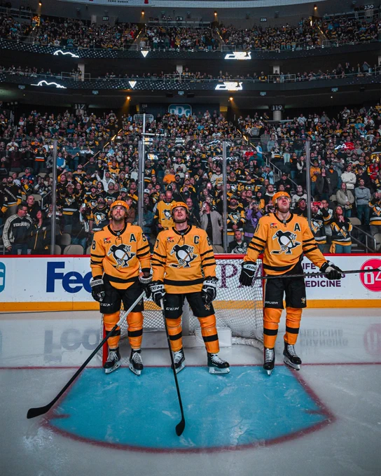 Photo of Kris Letang, Sidney Crosby, and Evgeni Malkin. 