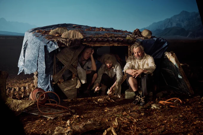 Robert Webb, Krystal Evans and David Mitchell dressed as dishevelled politicians inside a small, makeshift shelter in the middle of a deserted landscape.