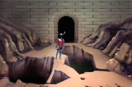 A scene from El Rescate del Talisman. A knight is treading a narrow pathway in the computerised dungeon, surrounded by trenches.