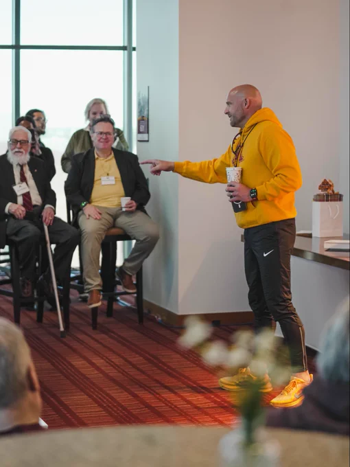 Coach Fleck speaking with the 1960 National Championship team and their families.