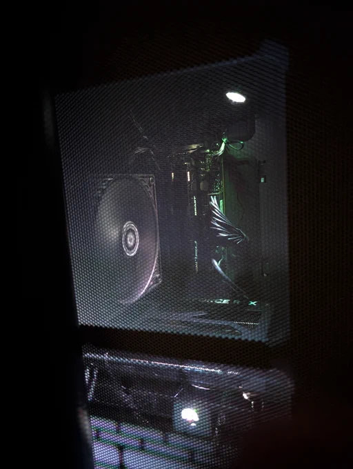 The inside of my PC case as seen through the mesh window, with the brightness of the spotlights turned down.