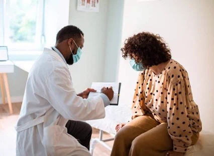 A doctor and patient conversating. 