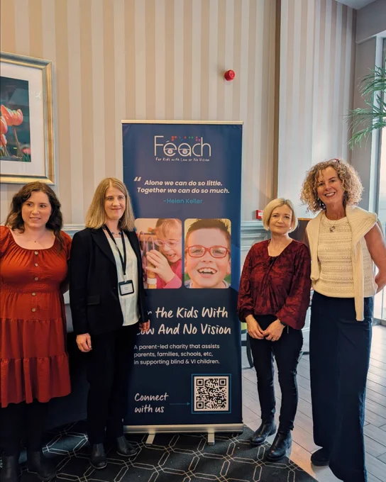 Emma and Lisa from Vision Ireland in bright colours stand beside Aoife  and Eithne from Feach in Black and White