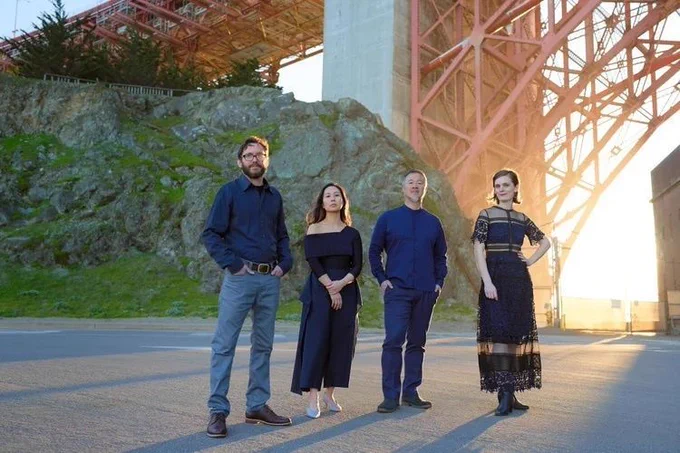 Members of the Del Sole Quartet at Fort Point, San Francisco, with the arch of the Golden Gate Bridge behind them. Left to right: Benjamin Kreith, Hyeyung Sol Yoon, Charlton Lee, and Kathryn Bates. Photo: AFW Productions & Chris Yeh (as listed).