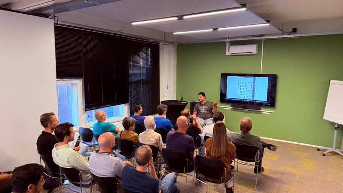 Derk-Jan Karrenbeld giving a talk in front of the meetup audience. 