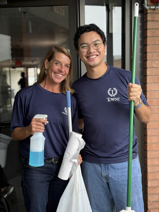 Smiling volunteers clean windows and balconies at The Doorways
