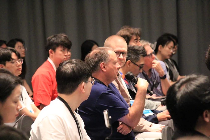 Attendee asking question during a paper session