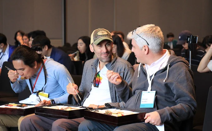 Attendees eating food at the industry session