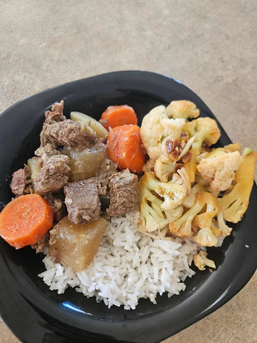 Dinner as described served on a squareish black soup plate.