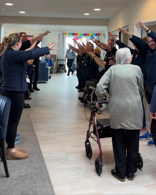 Staff form a guard of honour as Nancy, 104, walks to her party at our Rustington Centre