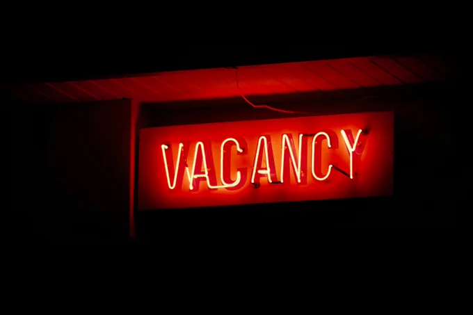 Red glowing LED sign with the words VACANCY