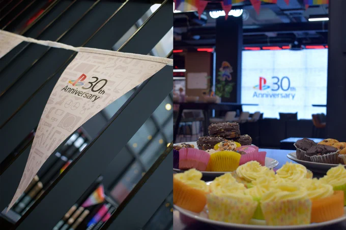 PlayStation's 30th Anniversary celebration featuring a banner and a table with assorted cupcakes and pastries. A screen in the background also displays the 30th Anniversary logo