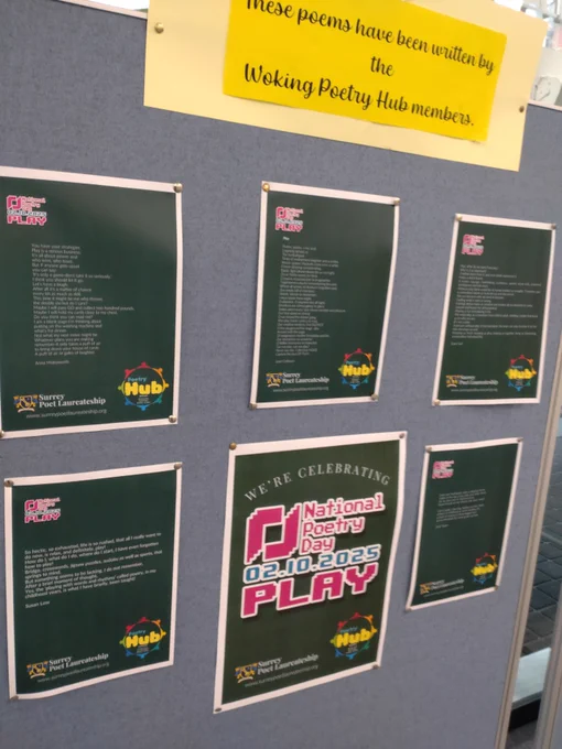 Poetry Day poems about play pinned on board.