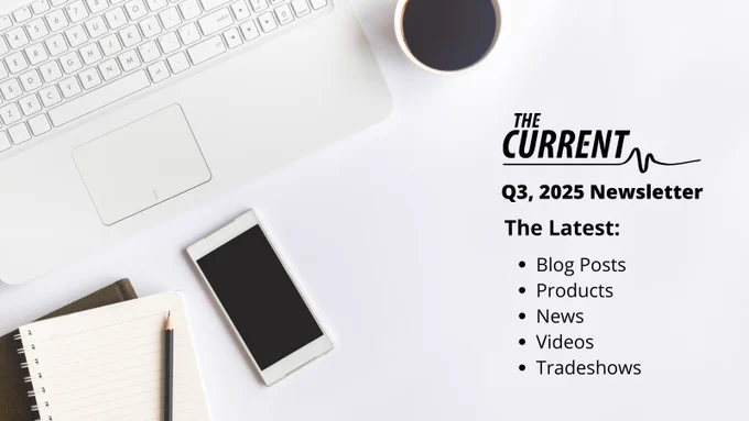 Desk with laptop, smartphone, notebook, pencil, and coffee next to text promoting 'The Current' Q3 2025 newsletter featuring blog posts, products, news, videos, and tradeshows.