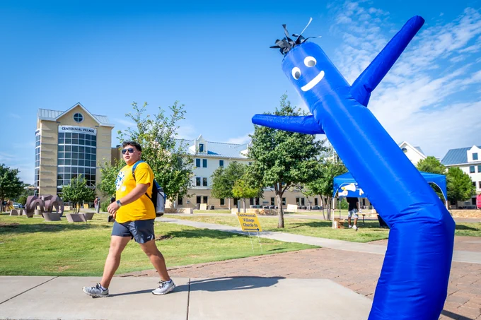 A photo of an Angelo State Residence Hall with students moving into the building.