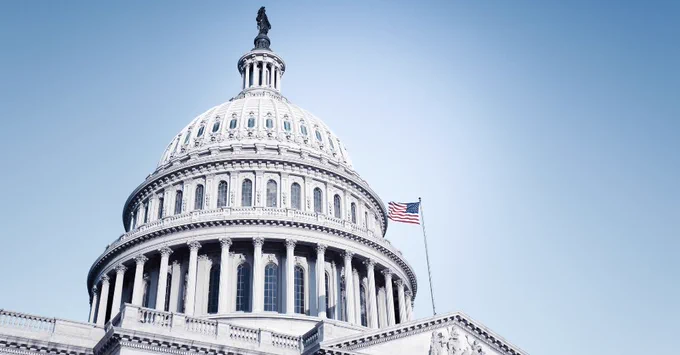 The US Capitol against a clear blue sky.