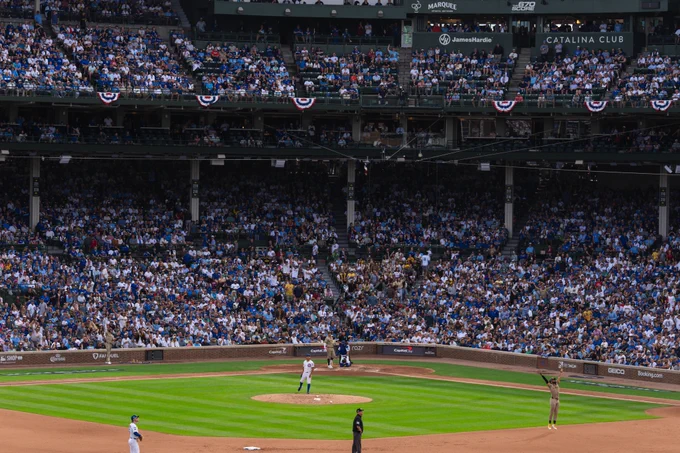 Manny Machado, Fernando Tatis Jr., and a packed crowd at Wrigley Field watch as the ball Manny just hit leaves the field for a home run.