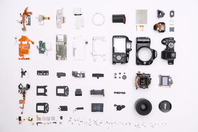 A detailed flat lay of disassembled camera components showcasing intricate electronics.