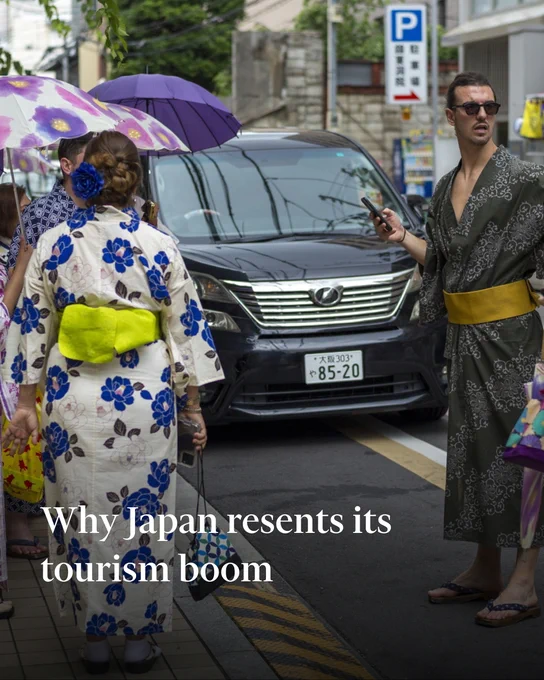 Tourists dressed in kimonos explore Kyoto