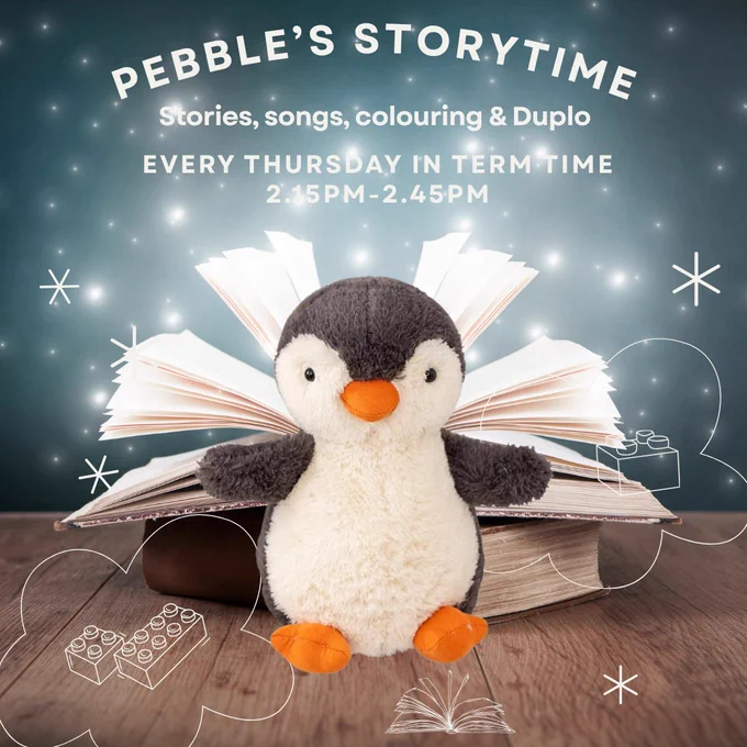 A book open with stars floating out of it with our Pebble penguin mascot sitting in front. 