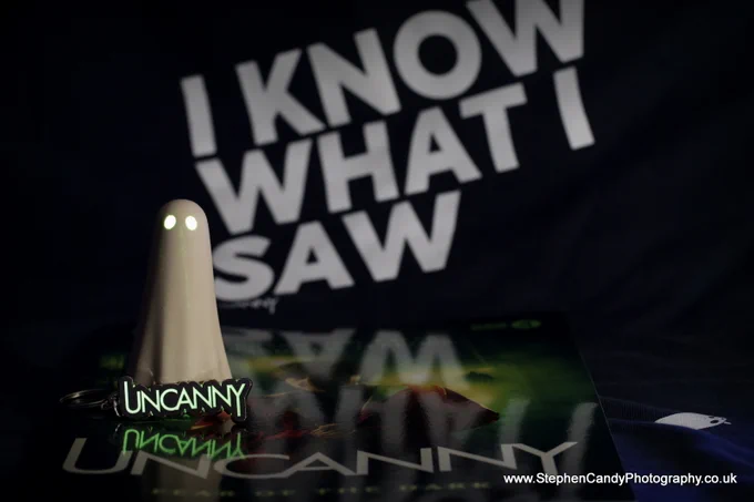 Glow in the dark Uncanny keyring, on the "Fear of the Dark" programme with a York Ghost (also glowing) in front of the "I Know What I Saw" sweatshirt.