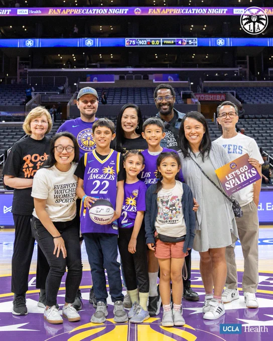 Malachi and his family posing for a photo on center court