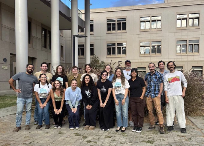 Over a dozen SBG students pose for a photo in an outdoor courtyard.