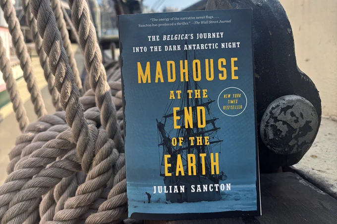 Photograph depicting a book balanced on a coil of ropes.
