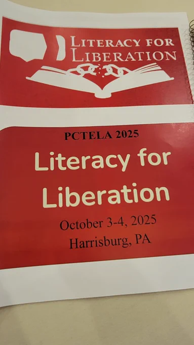 Paper program on a light colored table reading "PCTELA 2025 Literacy for Liberation October 3-4, 2025 Harrisburg, PA"