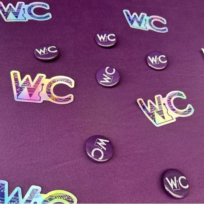 Women in Computing club at RIT pins and stickers at table 