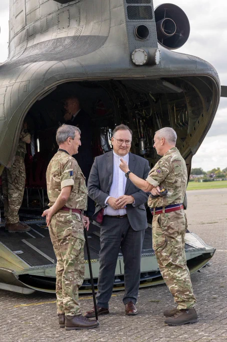A photograph of Presbyterian Moderator Dr Trevor Gribben (centre) at the rear of a Chinook helicopter talking to one of  PCI's chaplains  in the Royal Air Force, during his recent visit to England.
