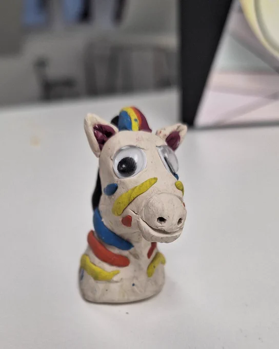 Small handmade playdough zebra figure decorated with googly eyes and colourful playdough