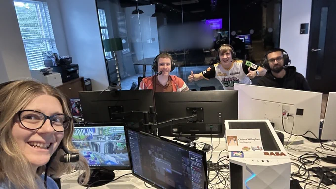 A photo of the team working in-person on the production of GSSD Live 12 at Cubed! 2025.

Holding the camera in front of the desk is Chelsea. Sitting on the other side of the desk are Bez, Stuart, and Aaron.