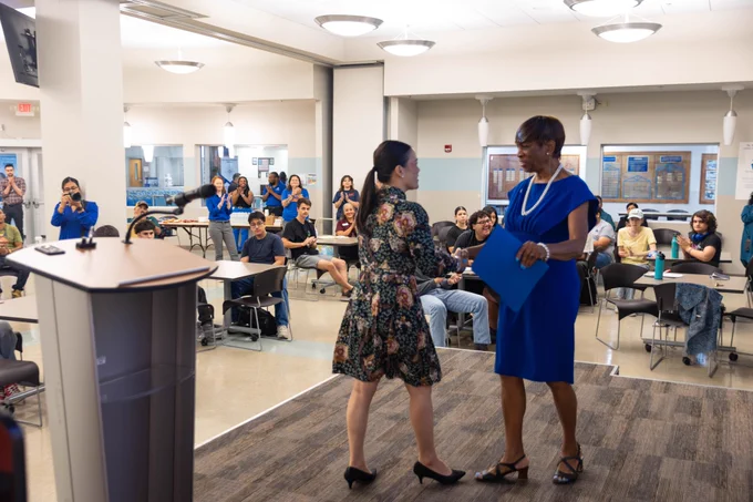 Mayor Jones shakes hands with Dr. Loston as she steps down from the stage.