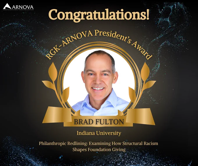 A gold and black congratulatory graphic featuring Dr. Brad Fulton, recipient of the 2025 RGK–ARNOVA President’s Award, with the project title Philanthropic Redlining and the ARNOVA logo.
