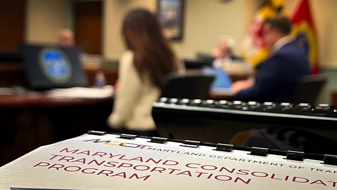 Close-up of a Maryland Department of Transportation document titled 'Maryland Consolidated Transportation Program' on a table in a meeting room.
